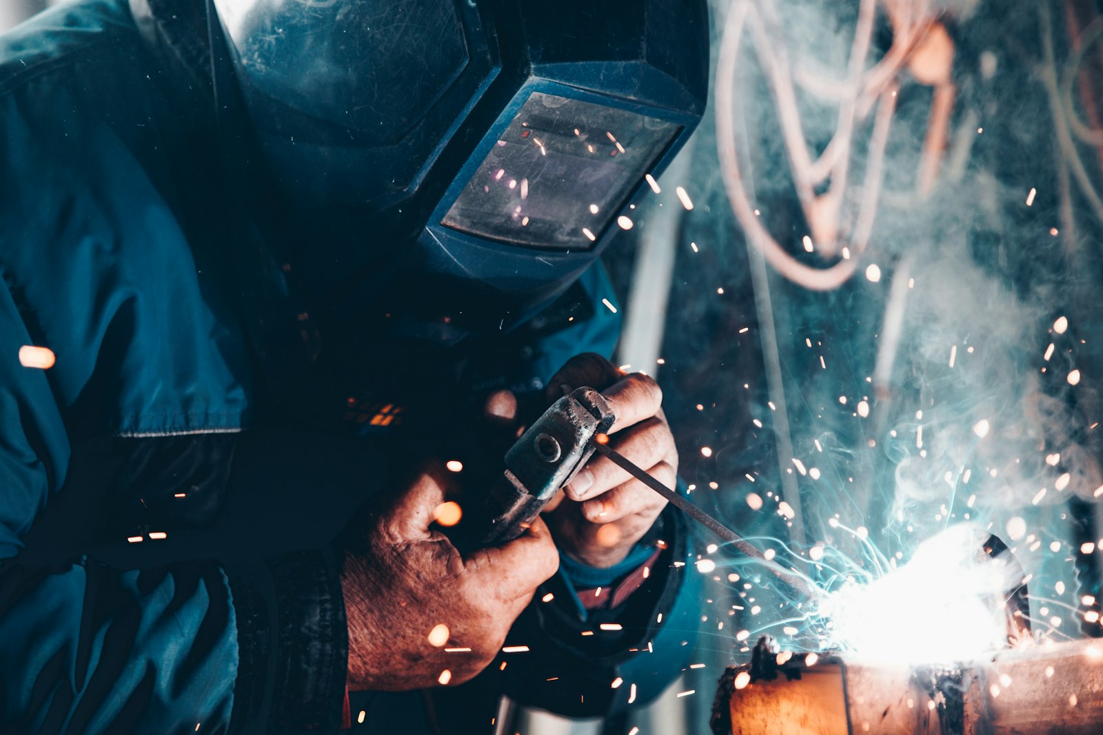 Welder working on a metal fabrication piece